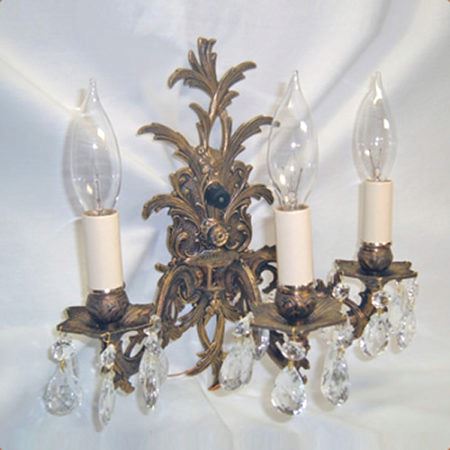 Three-armed cast brass wall sconce