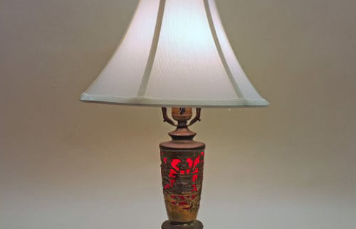 Unusual table lamp with wind-up music box in base