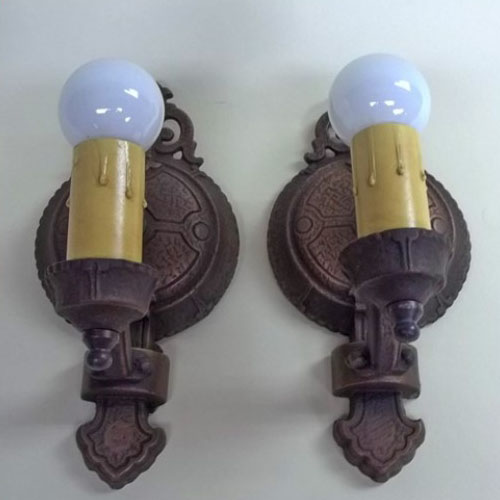Pair of single-armed cast iron wall sconces