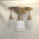 Brass flush mount ceiling fixture with three lights