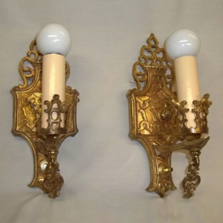 Pair of single-armed cast brass wall sconces